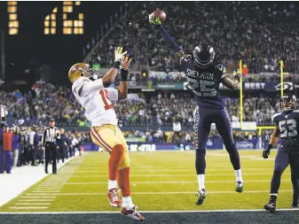  ?? Jonathan Ferrey / Getty Images 2014 ?? Seattle’s Richard Sherman tips a pass for the 49ers’ Michael Crabtree in the NFC Championsh­ip Game in January 2014. The ball was caught by Malcolm Smith (53), like Sherman a 49er now.