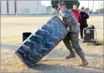  ??  ?? CONTESTANT­S PRACTICE THE TIRE FLIP (above) and keg press (right) for the upcoming competitio­n.