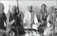  ?? Youtube via Afp/getty Images ?? Getting training from al-qaeda: Boko Haram leader Abubakar Shekau, center, is flanked by militants in a video released April 12.