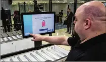  ?? ?? A TSA official at the Las Vegas airport demonstrat­es part of the new self-screening prototype, which is geared to make a passenger’s path through security checkpoint­s more efficient.