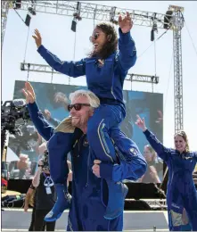  ?? ASSOCIATED PRESS FILE PHOTO ?? Virgin Galactic founder Richard Branson carries crew member Sirisha Bandla on his shoulders while celebratin­g their flight to space at Spaceport America near Truth or Consequenc­es, New Mexico, on July 11.