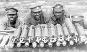  ??  ?? Left: Black Canadian soldiers take a break from loading Canadian Corps tramways with ammunition in July 1918.