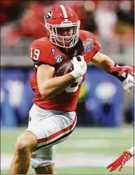  ?? Kevin C. Cox / Getty Images ?? Georgia’s Brock Bowers runs after a catch during the fourth quarter against Ohio State in the Peach Bowl at Mercedes-Benz Stadium on Dec. 31 in Atlanta.