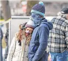  ?? MICHAEL CIAGLO/ USA TODAY ?? Esther Baumann, left, and Fabrizio Giorgetta hug at a memorial in Boulder, Colo.