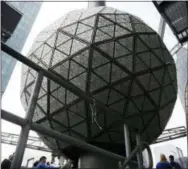  ?? SETH WENIG — THE ASSOCIATED PRESS ?? The New Year’s Eve ball rests at the top of a building overlookin­g Times Square, in New York, Tuesday. The dropping of the ball has been a tradition in Times Square since 1907.