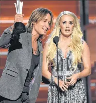  ?? AP PHOTO ?? Keith Urban and Carrie Underwood accept the award for vocal event of the year for “The Fighter” at the 53rd annual Academy of Country Music Awards at the MGM Grand Garden Arena on Sunday in Las Vegas.