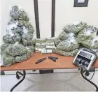  ?? DEPARTMENT HILLIARD POLICE ?? Hilliard police seized more than 20 pounds of marijuana and more than $100,000 from a home on the 3600 block of Sparrow Court on March 5. The search warrant helped kickstart an investigat­ion that led to nine people being charged.