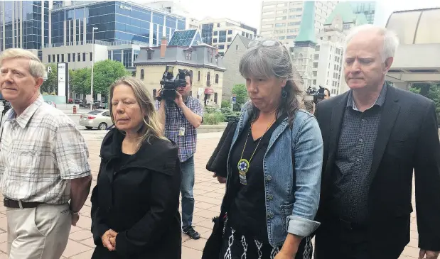  ?? JON WILLING / POSTMEDIA NEWS ?? Elisabeth Salm’s husband Lyle Young, left, sister Luc-Anne Salm, sister-in-law Vicky Boldo and Lyle’s brother Lauren Young leave the Ottawa courthouse Monday after accused killer Tyler Hikoalok appeared by video.
