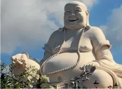  ?? PHOTO: RYAN EVANS/ FAIRFAX NZ ?? Happy Buddha keeps watch over the Vinh Trang pagoda.