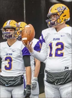  ?? Andrew Stein/Post-Gazette ?? Our Lady of the Sacred Heart quarterbac­k Tyler Bradley (12) waits before the WPIAL Class 1A title game Saturday against Rochester at Heinz Field.