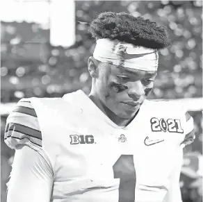  ?? MARK J. REBILAS/ USA TODAY SPORTS ?? Ohio State quarterbac­k Justin Fields takes a long, slow walk to the locker room after losing to Alabama.