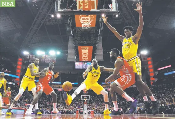  ?? Photos by David J. Phillip / Associated Press ?? The Warriors’ Draymond Green (23) kicks the ball as Kevin Durant (left) and Damian Jones (15) help defend against Rockets Clint Capela (15) and James Harden.