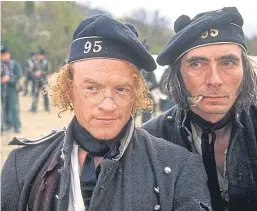  ??  ?? Jason Salkey, left, was cast in Sharpe’s Rifles in 1992 and played Harris, one of Sharpe’s ‘chosen men’. Salkey, pictured with John Tams, is a huge fan of the series and the history behind it and often participat­es in related military events.