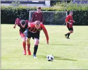  ?? 01_B34AAFC09 ?? Players mirror each other in lunging for the ball with Arran’s Adam McNicol securing possession.