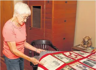  ?? BRENDAN MILLER/POSTMEDIA NETWORK ?? Hazel Perrier poses for a photo with a quilt that highlights the stories of British Home Child descendant­s.