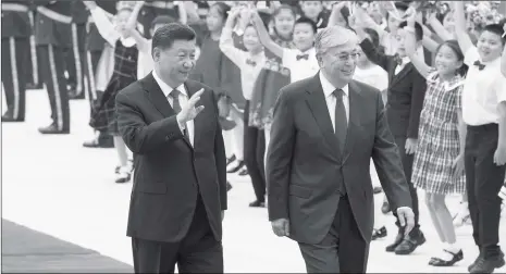 ?? Photo: Xinhua ?? Chinese President Xi Jinping (left) and Kazakh President Kassym-Jomart Tokayev walk together at the square of the Great Hall of the People in Beijing on Wednesday.