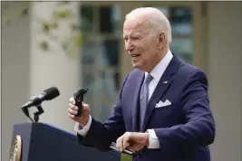  ?? CAROLYN KASTER — THE ASSOCIATED PRESS ?? President Joe Biden holds pieces of a 9mm pistol as he speaks in the Rose Garden of the White House in Washington on Monday.