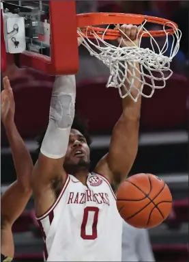  ?? (NWA Democrat-Gazette/J.T. Wampler) ?? Arkansas senior forward Justin Smith dunks for two of his 22 points during the Razorbacks’ victory over Oral Roberts on Sunday at Walton Arena in Fayettevil­le. Smith also had a career-high 17 rebounds. More photos available at arkansason­line.com/1221uaoru.