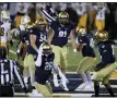  ?? NEWS-HERALD FILE ?? Mentor graduate Kyle Ulshafer (91) celebrates after his sack and forced fumble of Baldwin Wallace QB Kegan Armitage on March 12 during John Carroll’s 28-17 victory on March 12. Also pictured is teammate and fellow Mentor grad Dan Garcar (54).