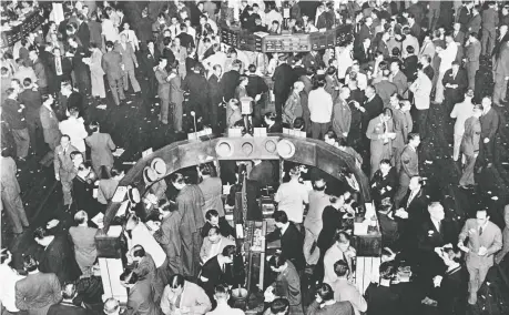  ?? AFP/GETTY IMAGES FILES ?? Traders work in Wall Street in New York in October 1929. The 1929 crash took a decade worth of sacrifices and the Second World War to mend fully. The recent stock market and coronaviru­s catastroph­es are manageable but their duration is a big unknown, says Diane Francis.