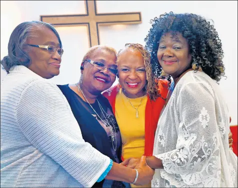  ?? KELLY WILKINSON/AP ?? Maxine Bryant, 60, second from right, stands with her sisters at Scott United Methodist Church Oct. 13. Adopted as a child, she was reunited with her siblings after 60 years. Her sisters are Donzella Triplett, 69, from left, Birdie Peoples Ferguson, and Victoria Peoples, 67, right.