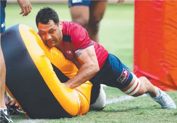  ??  ?? An older, wiser George Smith gets stuck into the tackle bags at training. Picture: DARREN ENGLAND