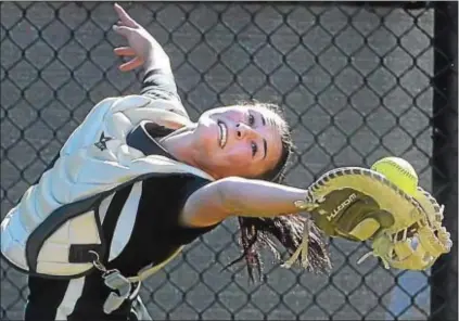  ?? PETE BANNAN — DIGITAL FIRST MEDIA ?? Interboro catcher Amber Seaman, here stabbing a foul ball out of the air in a District 1 Class 5A final against West Chester Henderson, put up a lot of power numbers for the Bucs. She also didn’t strike out all season.