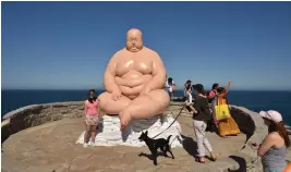  ?? — AFP ?? Visitors look at a sculpture titled Horizon by Mu Boyan, part of the annual Sculpture by the Sea exhibiton in Sydney on Friday.