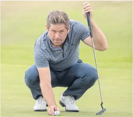  ??  ?? England’s Robert Rock waits to putt on the 17th during the second round.