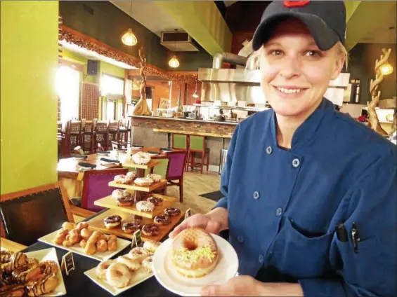  ?? JANET PODOLAK — THE NEWS-HERALD ?? Pastry chef Erica Coffee, who makes the donuts for Sol’s new Donut Bar, likes the lemon donuts best.