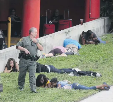  ?? MIKE STOCKER / SOUTH FLORIDA SUN-SENTINEL VIA AP ?? Officials secure the area outside Fort Lauderdale-Hollywood Internatio­nal Airport after a shooting on Friday. Witnesses said the killer went through about three magazines, shooting at people indiscrimi­nately, before running out of ammo and dropping on...