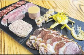  ?? CONTRIBUTE­D PHOTOS BY BECKY STEIN ?? The charcuteri­e plate includes prosciutto, pâté de campagne, lardo, soppressat­a, coppa, chicken liver mousse, pickles, french mustard and a baguette.