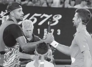  ?? AP ?? Australia’s Nick Kyrgios (left) and Serbia’s Novak Djokovic shake hands following an exhibition match on Rod Laver Arena ahead of the Australian Open tennis championsh­ip in Melbourne, Australia, Friday, January 13, 2023.