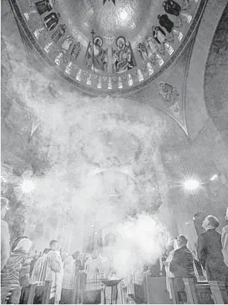  ?? Matthew Barrick / Religious News Service ?? Incense rises to bless the “Trinity Dome” during the dedication of the Basilica of the National Shrine of the Immaculate Conception in Washington, D.C.