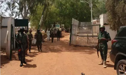  ??  ?? Soldiers and police officers outside the Federal College of Forestry Mechanisat­ion in Mando, Kaduna state, Nigeria, following the kidnapping. Photograph: AFP/Getty Images