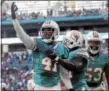  ?? LYNNE SLADKY — THE ASSOCIATED PRESS ?? Miami Dolphins cornerback Byron Maxwell (41) is congratula­ted by outside linebacker Jelani Jenkins (53), and free safety Michael Thomas (31) during a game last season.