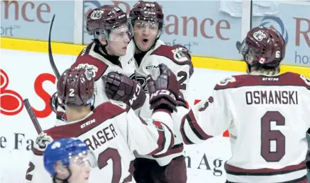  ?? CLIFFORD SKARSTEDT/EXAMINER ?? Peterborou­gh Petes players Cole Fraser, Zach Gallant, Nikita Korostelev and Austin Osmanski celebrate a goal as Sudbury Wolves' Zack Malik looks on during OHL action Dec. 7 at the Memorial Centre. The Petes return to action after the Christmas break in...