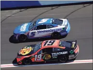  ?? Sean Gardner / Getty Images ?? Kyle Larson (5) and Martin Truex Jr. drive during practice for the NASCAR Cup Series Folds of Honor QuikTrip 500 at Atlanta Motor Speedway on Saturday.