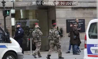  ?? CHRISTOPHE ENA/THE ASSOCIATED PRESS ?? A knife-wielding man shouting “Allahu Akbar” attacked French soldiers on patrol near the Louvre Museum.