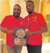  ?? Picture: SUPPLIED ?? CHAMP: Teris Ntutu and IBF president Daryl People will be at a hearing over Fuzile’s protest after his loss to Shavkat Rakhimov.