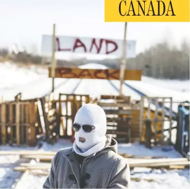  ?? JASON FRANSON / THE CANADIAN PRESS ?? Supporters of the Wet’suwet’en, who are opposed to the Coastal Gaslink pipeline, stand before a hastily-setup blockade of a CN Rail line just west of Edmonton on Wednesday.