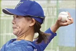  ?? AP photo ?? Eri Yoshida, a member of Japanese women’s team Agekke throws a knucklebal­l as she plays catch during a practice in Oyama, Tochigi prefecture, north of Tokyo, on Tuesday.