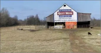  ?? TIMOTHY D. EASLEY — THE ASSOCIATED PRESS ?? Once it stored tobacco, now this 100 year old barn, seen in a photo and owned by former tobacco farmer Michael Vaughn, now displays a message for Kentuckian­s to quit smoking,