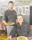  ?? MORNING CALL FILE PHOTO ?? Louie’s Italian Restaurant owner Louis Belletieri, seated, and his son Josh pose inside the restaurant’s dining room in 2014.