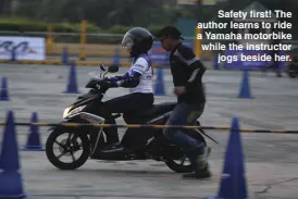  ??  ?? Safety first! The author learns to ride a Yamaha motorbike while the instructor jogs beside her.