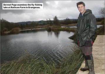  ??  ?? Dermot Page examines the fly-fishing lake at Rathcon Farm in Grangecon.