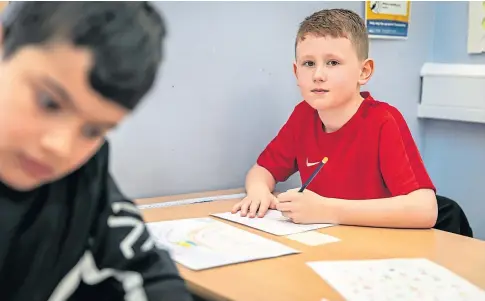  ??  ?? WRITE STUFF: Oliver Clark, whose mum is the manager at Turriff House, is just one of the pupils at St Clement’s RC Primary School who have been lifting the spirits of the care home residents. Pictures by Steve Brown.