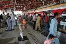  ?? Photograph: Arif Ali/AFP/Getty Images ?? The Orange Line will reduce the time to cross bustling Lahore by more than half.