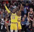  ?? CRAIG MITCHELL-DYER — ASSOCIATED PRESS ?? LeBron James, center, gestures against the Trail Blazers earlier this season in Portland, Ore.