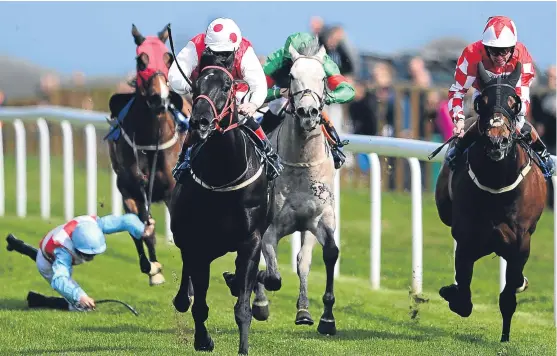  ?? Picture: Getty Images. ?? Secretfact, centre, ridden by Jimmy Quinn, races clear of Swendab, right, and Frank The Barber to win the myracing.com free horse racing tips Handicap Stakes at Bath yesterday as Luke Morris parts company with Powerful Dream.